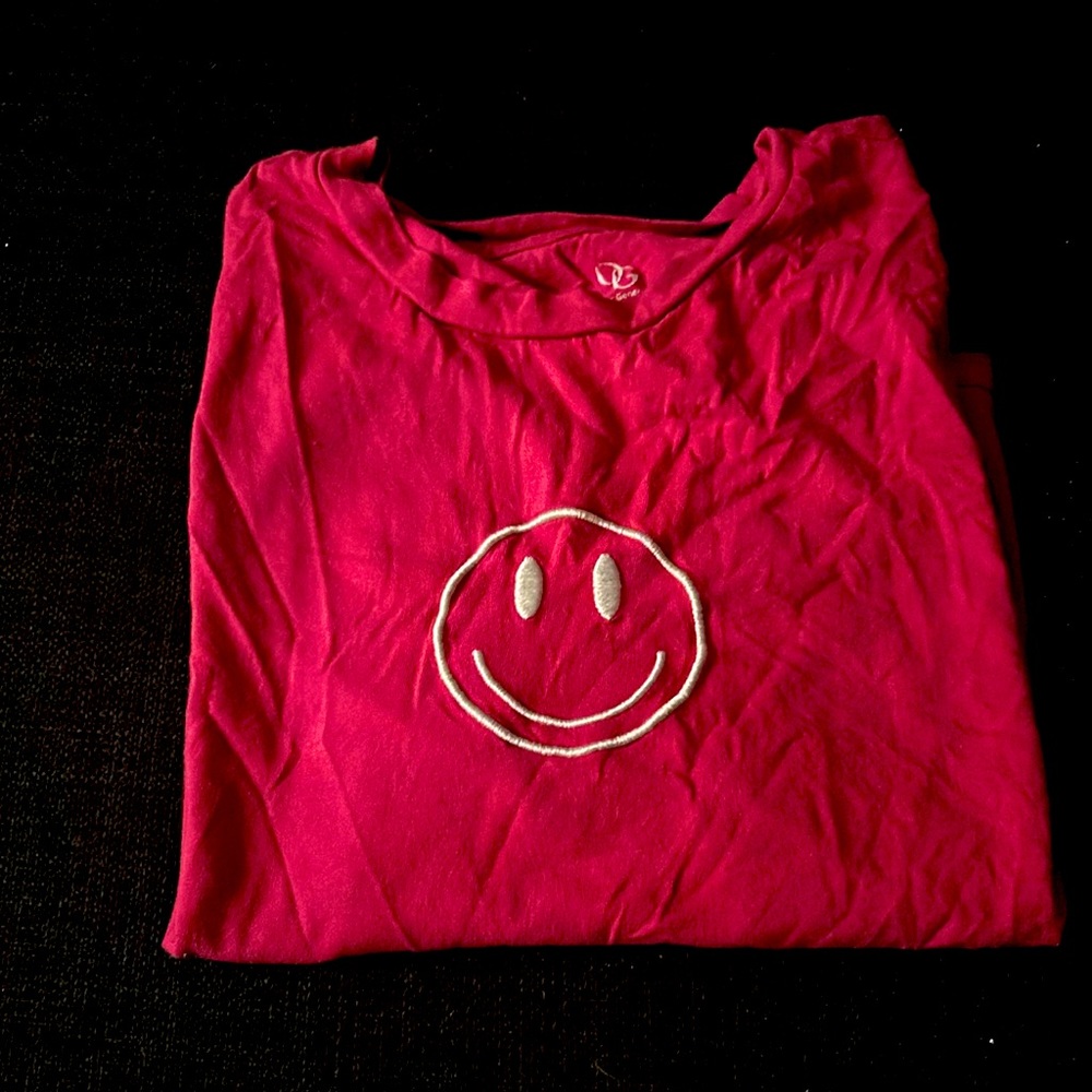 This shirt is a pink and bright cute top that looks good with blue jeans